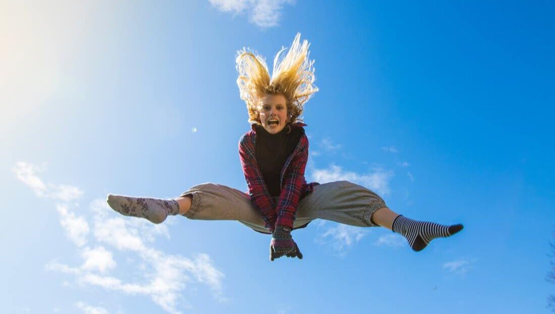 girl jumping into the sky